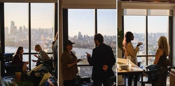 Guests talking by the windows at Level39 with the London skyline behind them